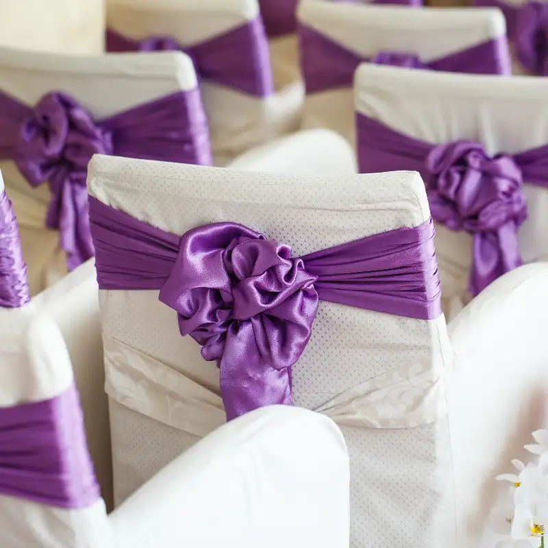 White chair covers with decorative sashes at a wedding venue near Bath